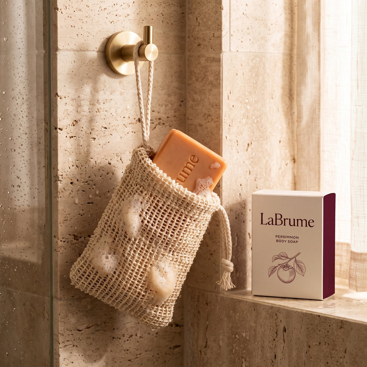 Soap bag hanging in the shower with LaBrume persimmon soap