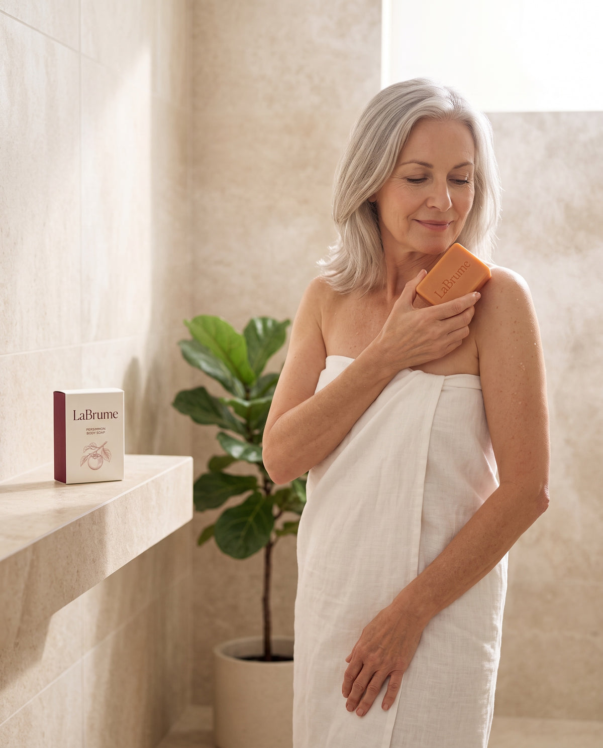 Woman using LaBrume Persimmon Body Soap after the shower